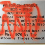 Engels 1976 plaque with graffiti; 2021.
